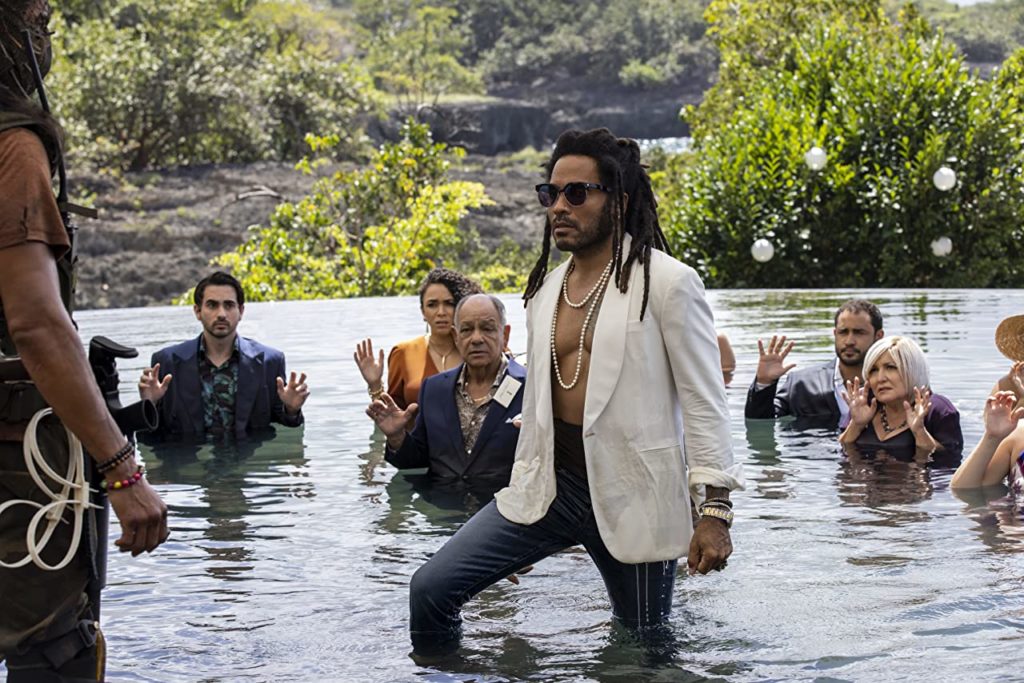 Lenny Kravitz in Shotgun Wedding. He's standing knee-deep in a pool wearing an open suit jacket with no shirt underneath.